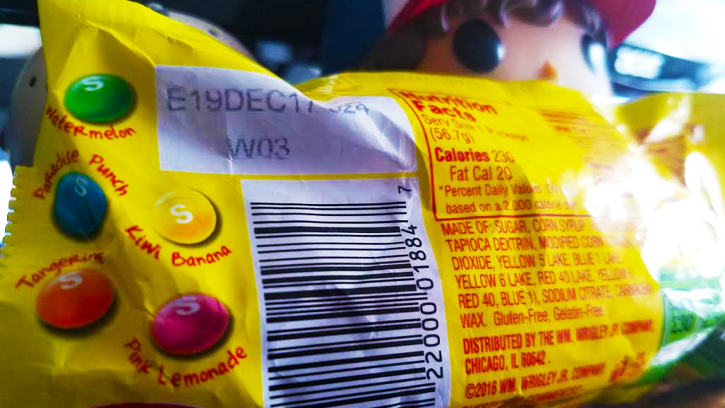 The back of a package of Brightside Skittles showing the full flavor assortment. Also a sliver of Dustin from Stranger Things' head.